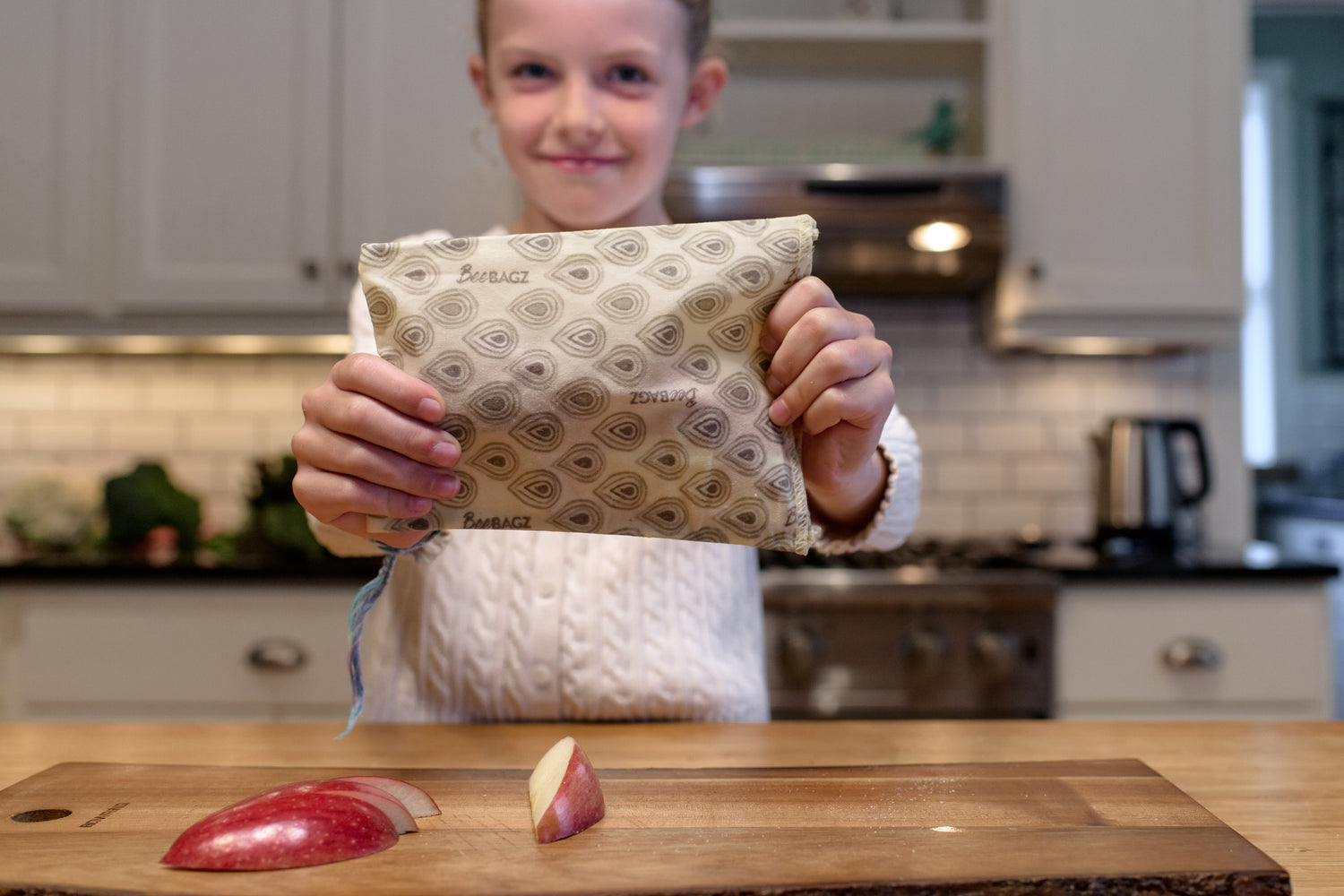 Girl holding beebagz with an apple