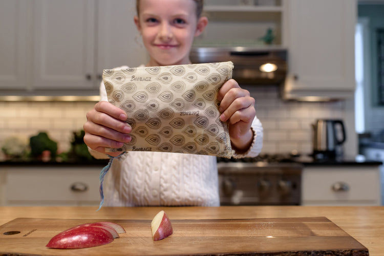 Girl holding beebagz with an apple